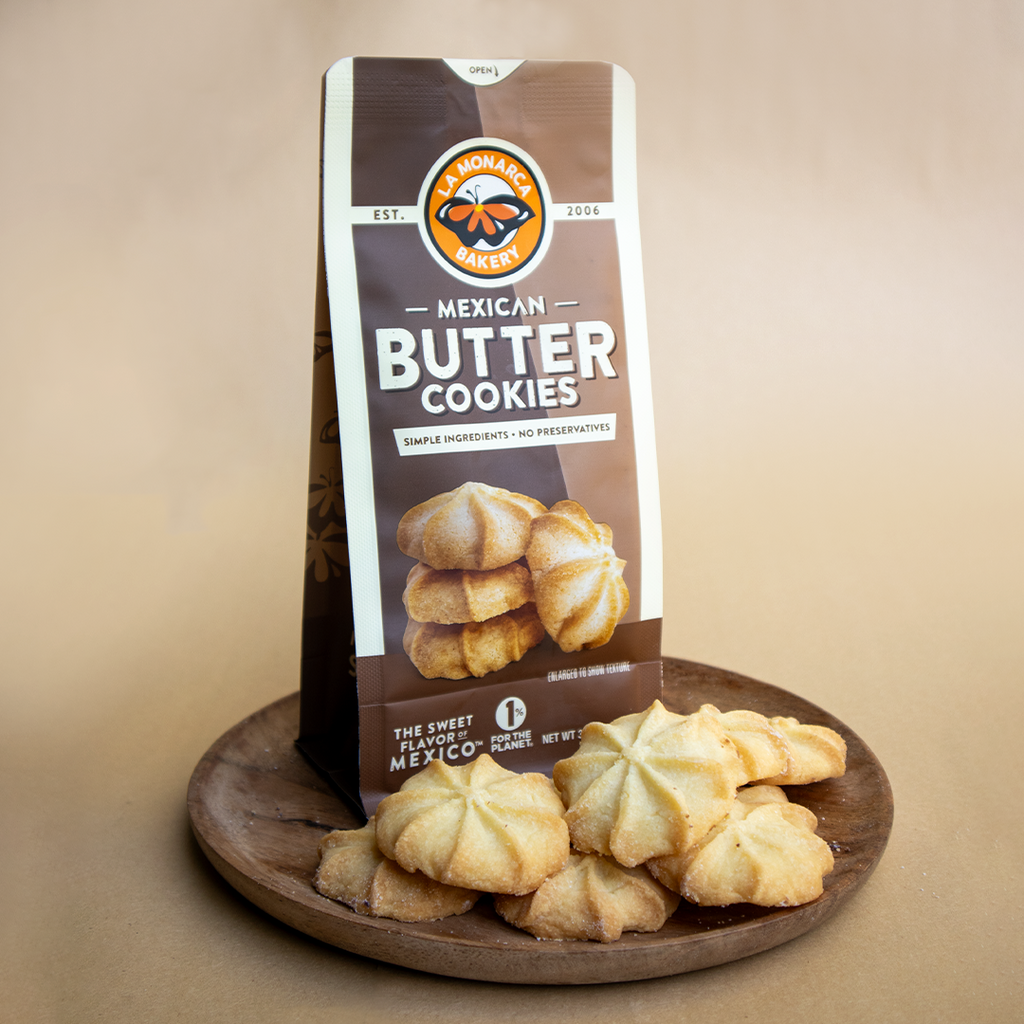 A plate of La Monarca Bakery Mexican Butter Cookies accompanied by packaging