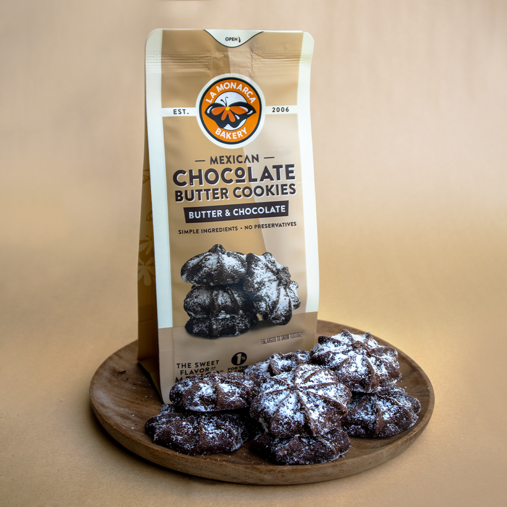 A plate of La Monarca Bakery Mexican Chocolate Butter Cookies accompanied by packaging